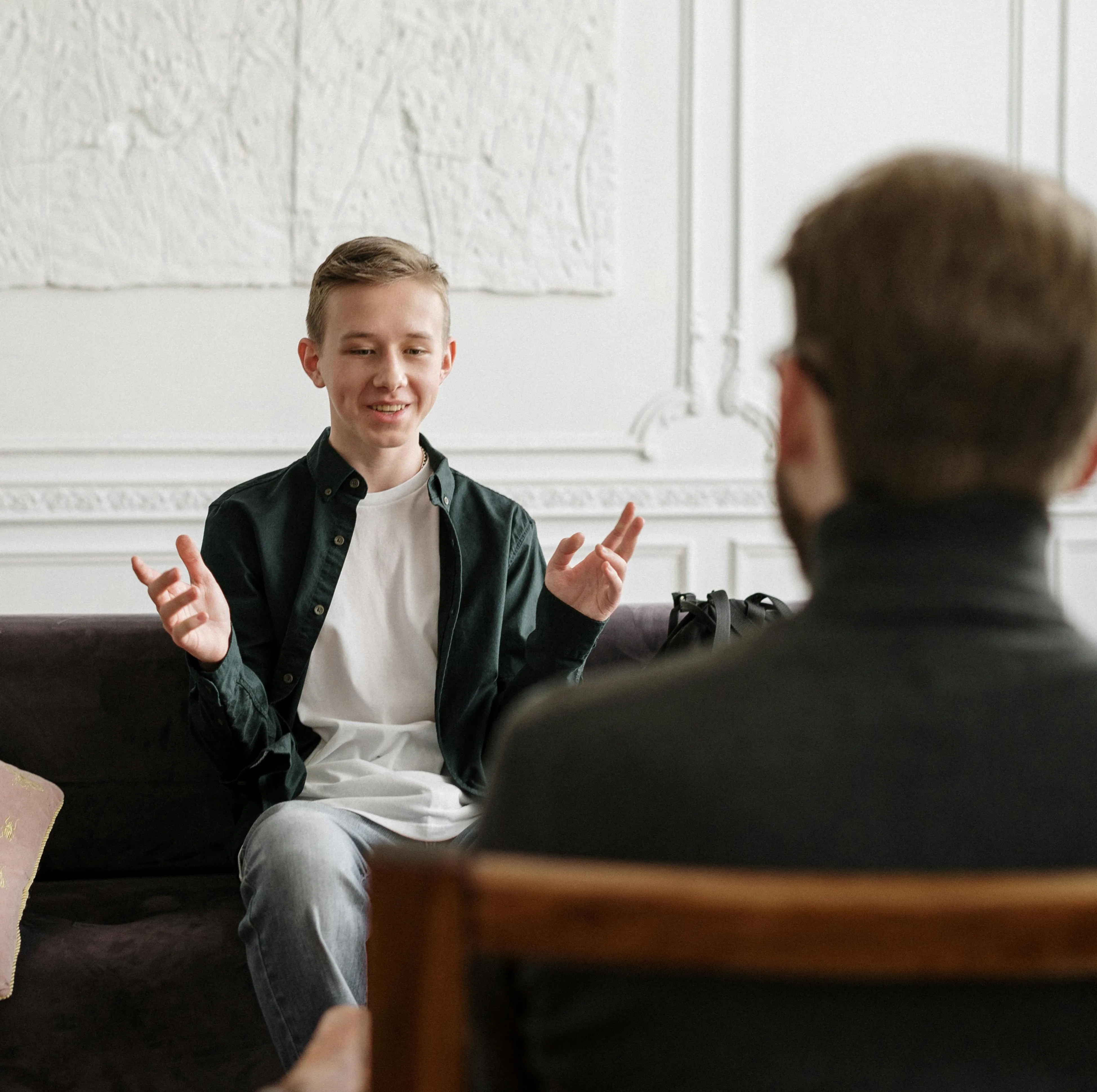 Two people sat opposite of eachother having a conversation